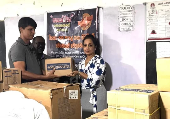 PBSS Group Chairman Dr. Madura Gamanayake and CEO Anjana Wijesinghe presenting school supplies for flood relief in Kandy.